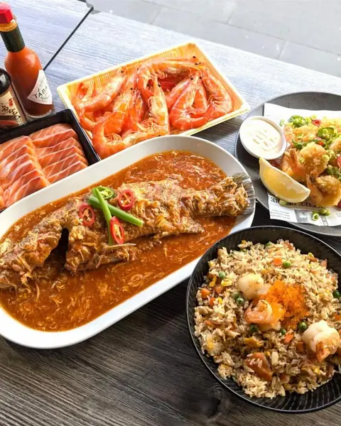 XO noodles, sashimi, a whole fish in sauce and fried rice on the table