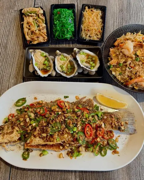 Seaweed salad, dressed oysters, fried rice and a whole grilled fish